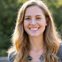 A professional portrait of an approachable woman, Emily, with a warm and inviting smile.